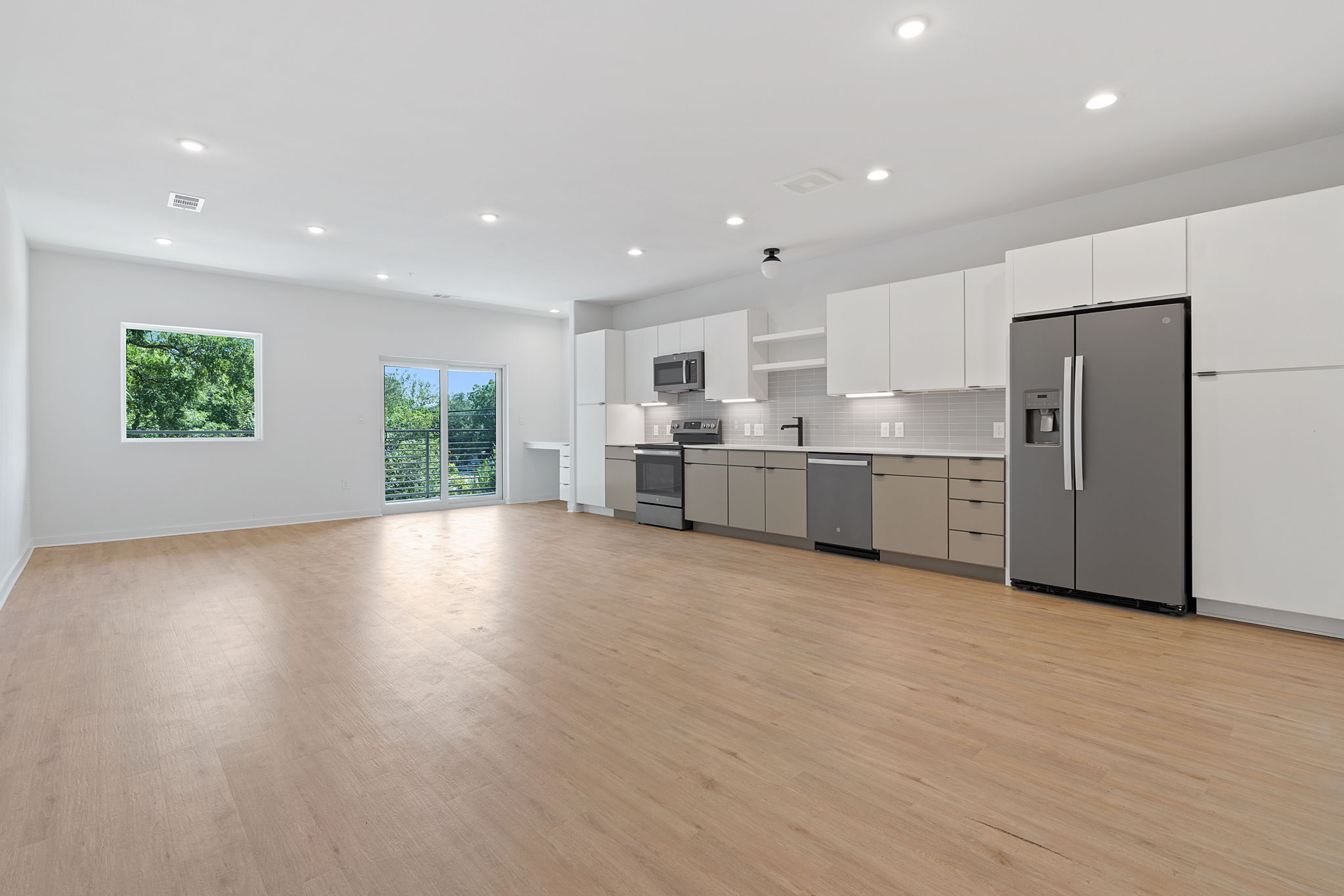 100 West Mockingbird Lane, Unit 202 Austin, TX 78745 - Photo 25 of 30 a view of kitchen with refrigerator microwave and wooden floor