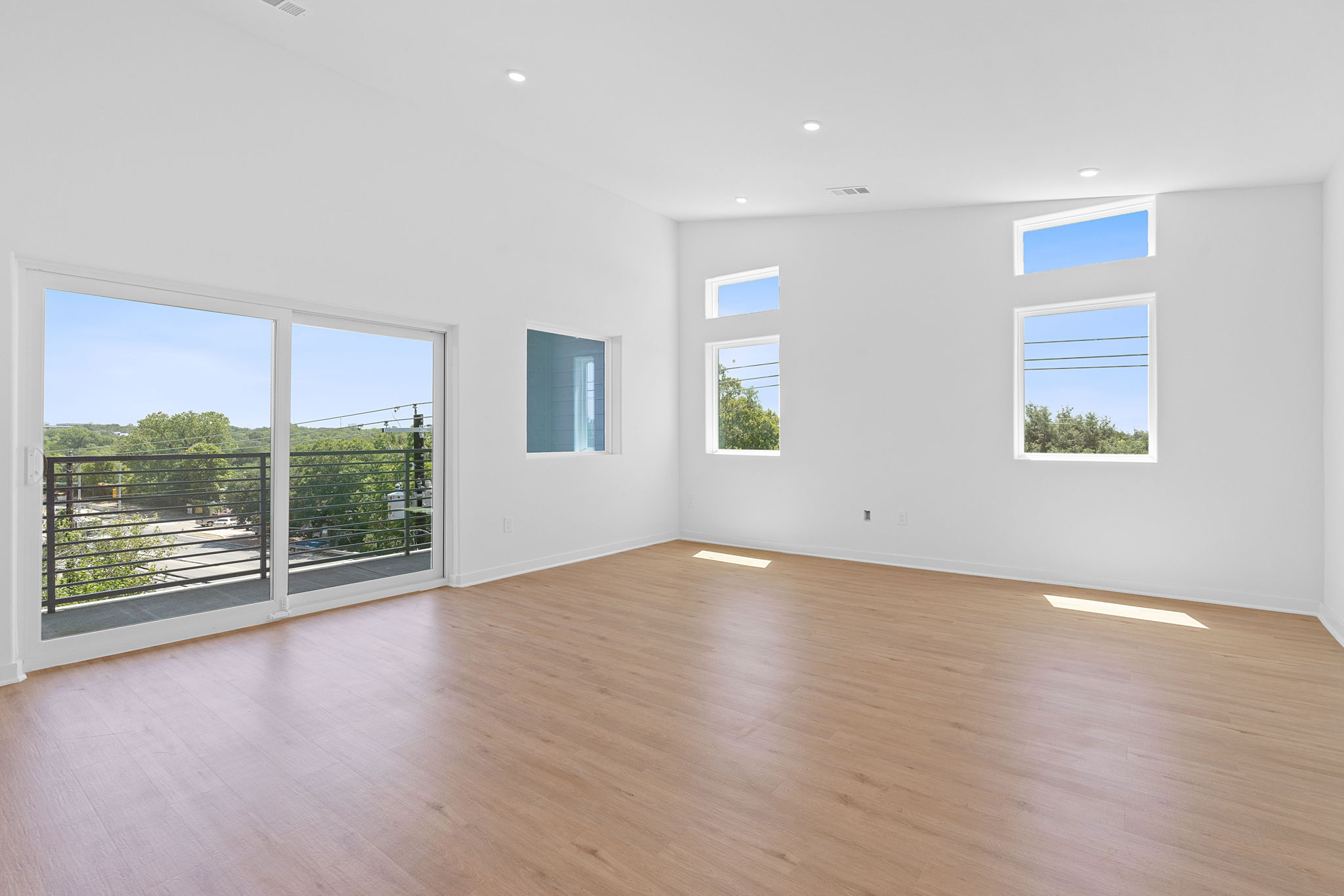 100 West Mockingbird Lane, Unit 202 Austin, TX 78745 - Photo 9 of 30 an empty room with wooden floor and windows