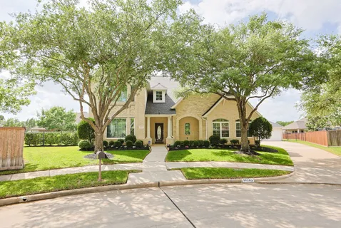 a front view of house with yard and green space