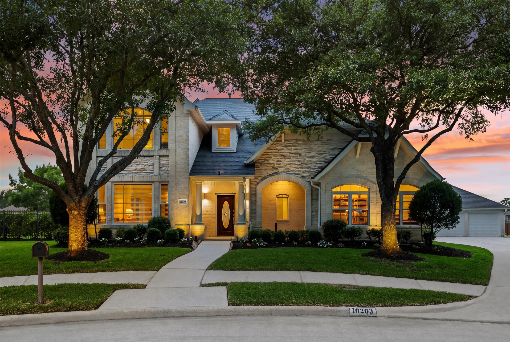 10203 Noble Pointe Court Spring, TX 77379 - Photo 2 of 50 Full brick and stone exterior with large covered porch. Sidewalks and cul-de-sac location. True 3 car front load garage. New garage doors (16' and 18') with Liftmaster openers.