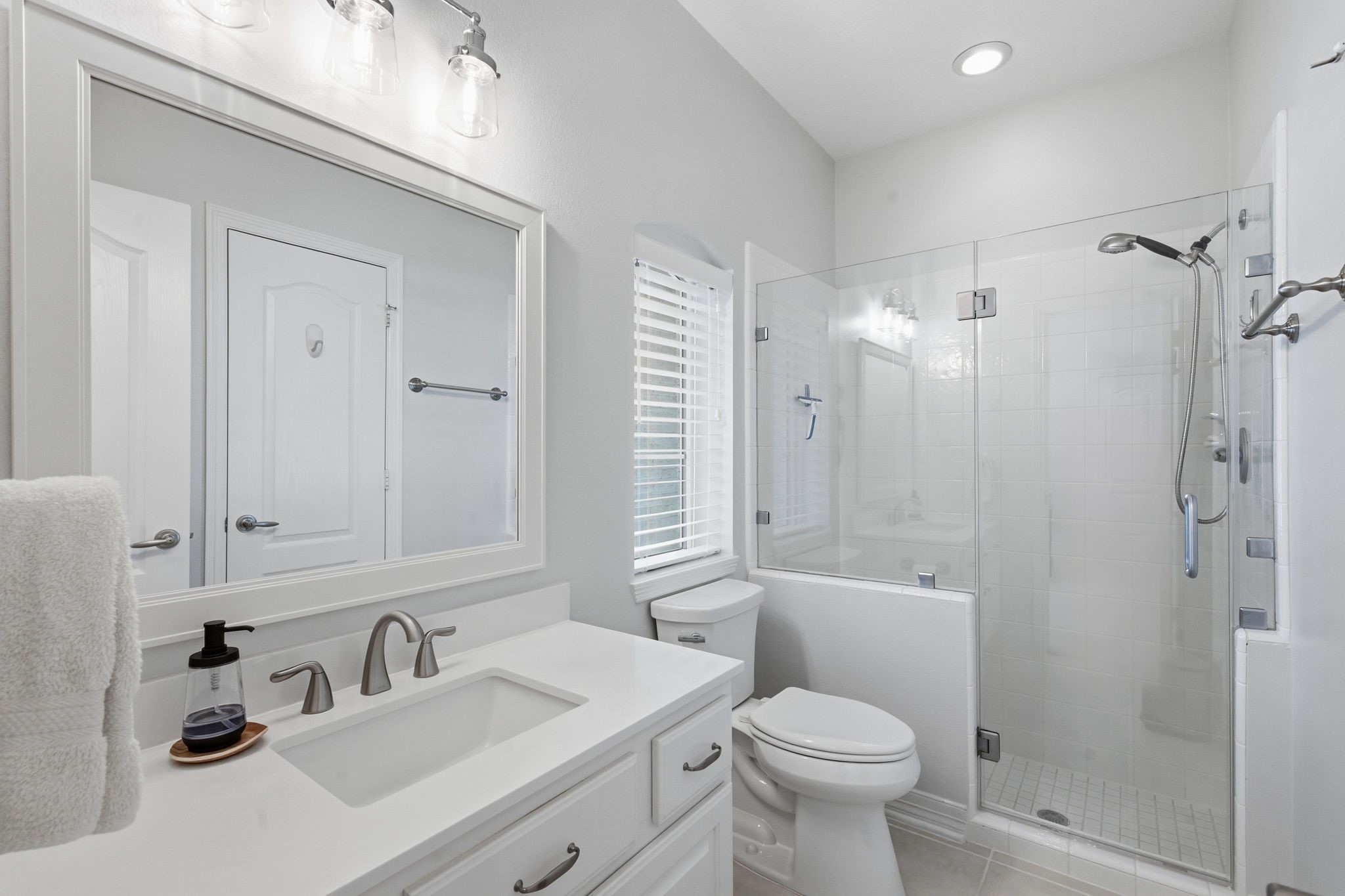 10203 Noble Pointe Court Spring, TX 77379 - Photo 29 of 50 Second full bath on main floor. Quartz counterd, new faucets, commode, vanity, mirror and frameless shower door
