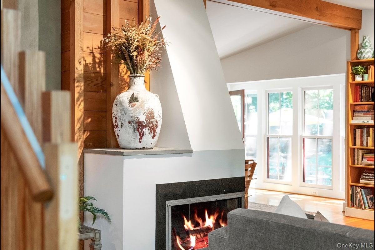 1821 Spring Valley Road Ossining, NY 10562 - Photo 15 of 48 Beyond the stunning fireplace, the dining area unfolds with a wall of windows that invites the sunlight to pour in.