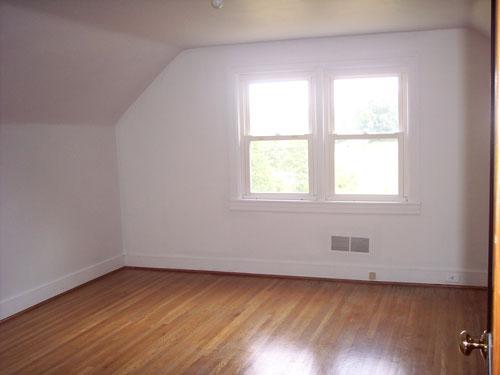 9890 Stewartsville Road Goodview, VA 24095 - Photo 13 of 16 an empty room with wooden floor and windows