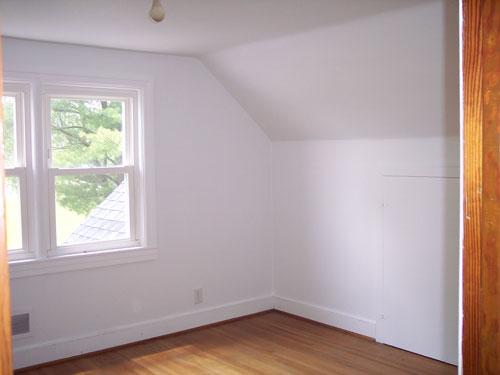 9890 Stewartsville Road Goodview, VA 24095 - Photo 14 of 16 an empty room with wooden floor and windows
