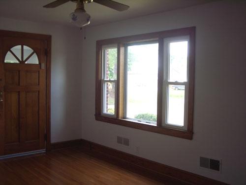 9890 Stewartsville Road Goodview, VA 24095 - Photo 9 of 16 an empty room with wooden floor and windows