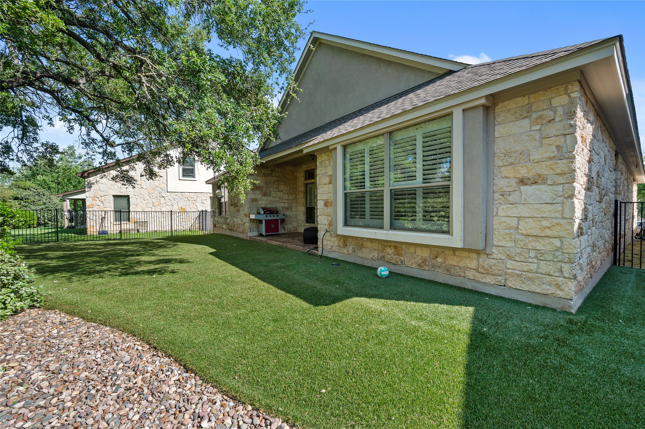 4512 Pyrenees Pass Bee Cave, TX 78738 - Photo 32 of 35 a view of a white house with a big yard and potted plants