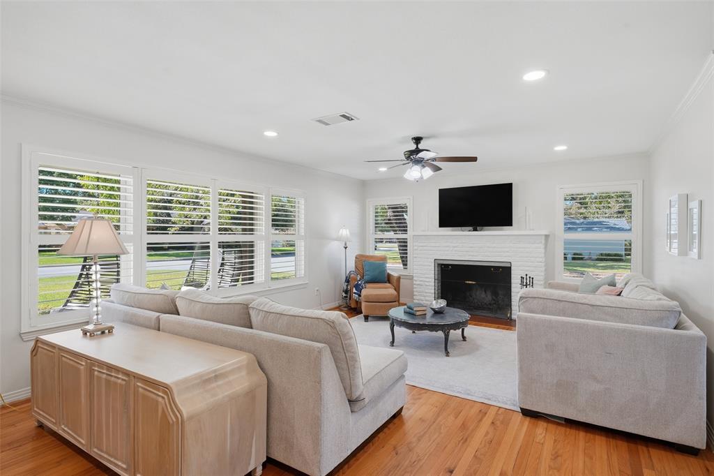 3712 Brighton Road Fort Worth, TX 76109 - Photo 3 of 33 Bright, spacious living room with warm hardwood floors, Plantations shutters frame large windows for ample natural light.