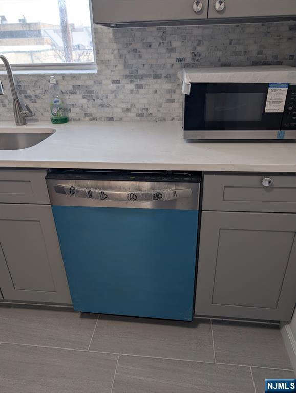 205 Bergen Turnpike, Unit 2E Ridgefield Park, NJ 07660 - Photo 4 of 9 a kitchen with a stove and a microwave