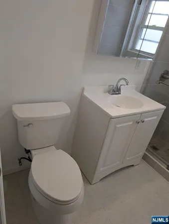 a bathroom with a shower a sink and a mirror