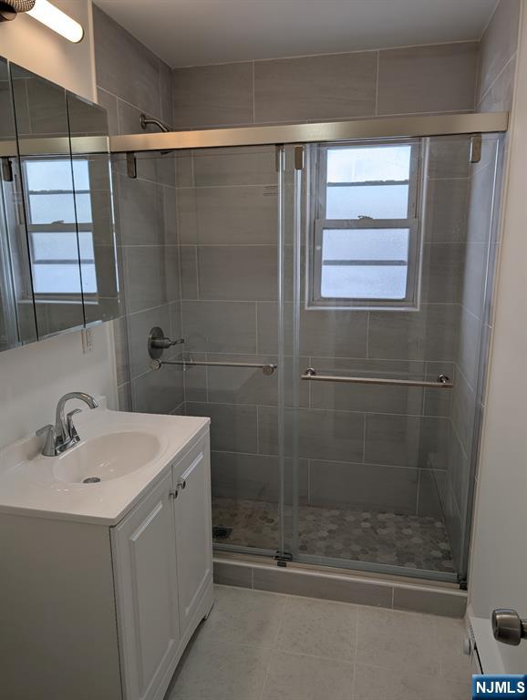 205 Bergen Turnpike, Unit 2E Ridgefield Park, NJ 07660 - Photo 8 of 9 a bathroom with a shower a sink and a mirror