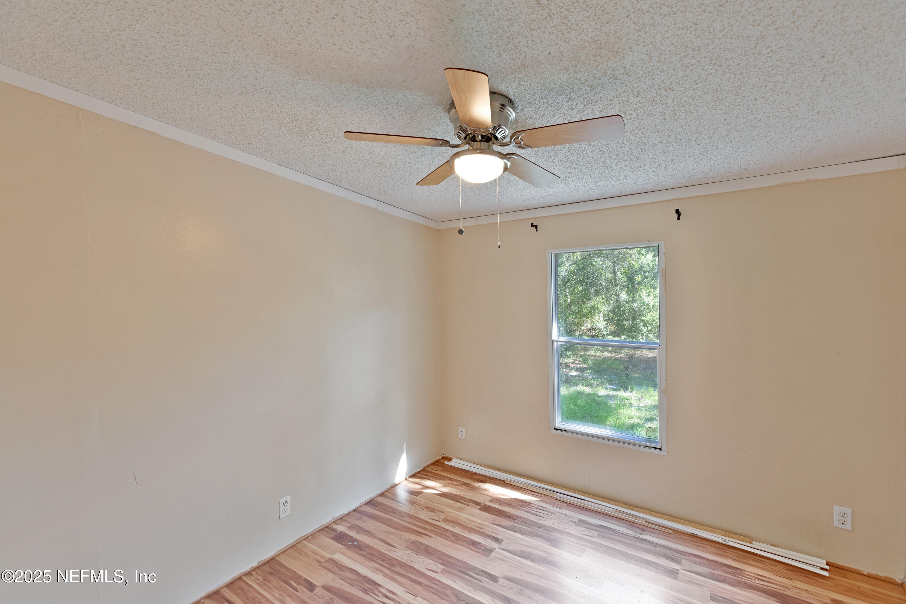 7463 Lilly Court Keystone Heights, FL 32656 - Photo 11 of 24 an empty room with a window and a fan