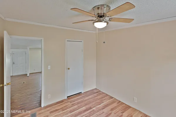 wooden floor in a hall with an empty room