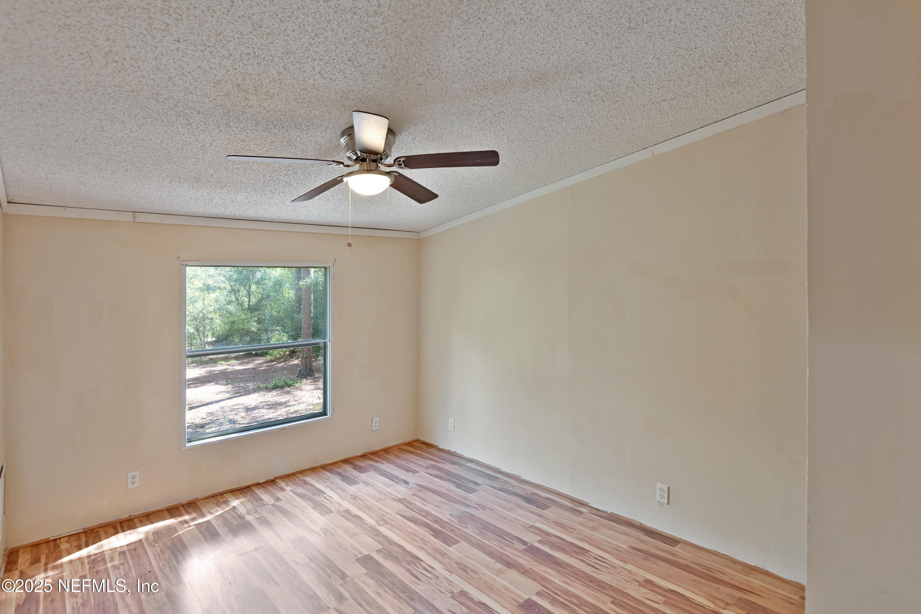 7463 Lilly Court Keystone Heights, FL 32656 - Photo 13 of 24 an empty room with a window and a ceiling fan