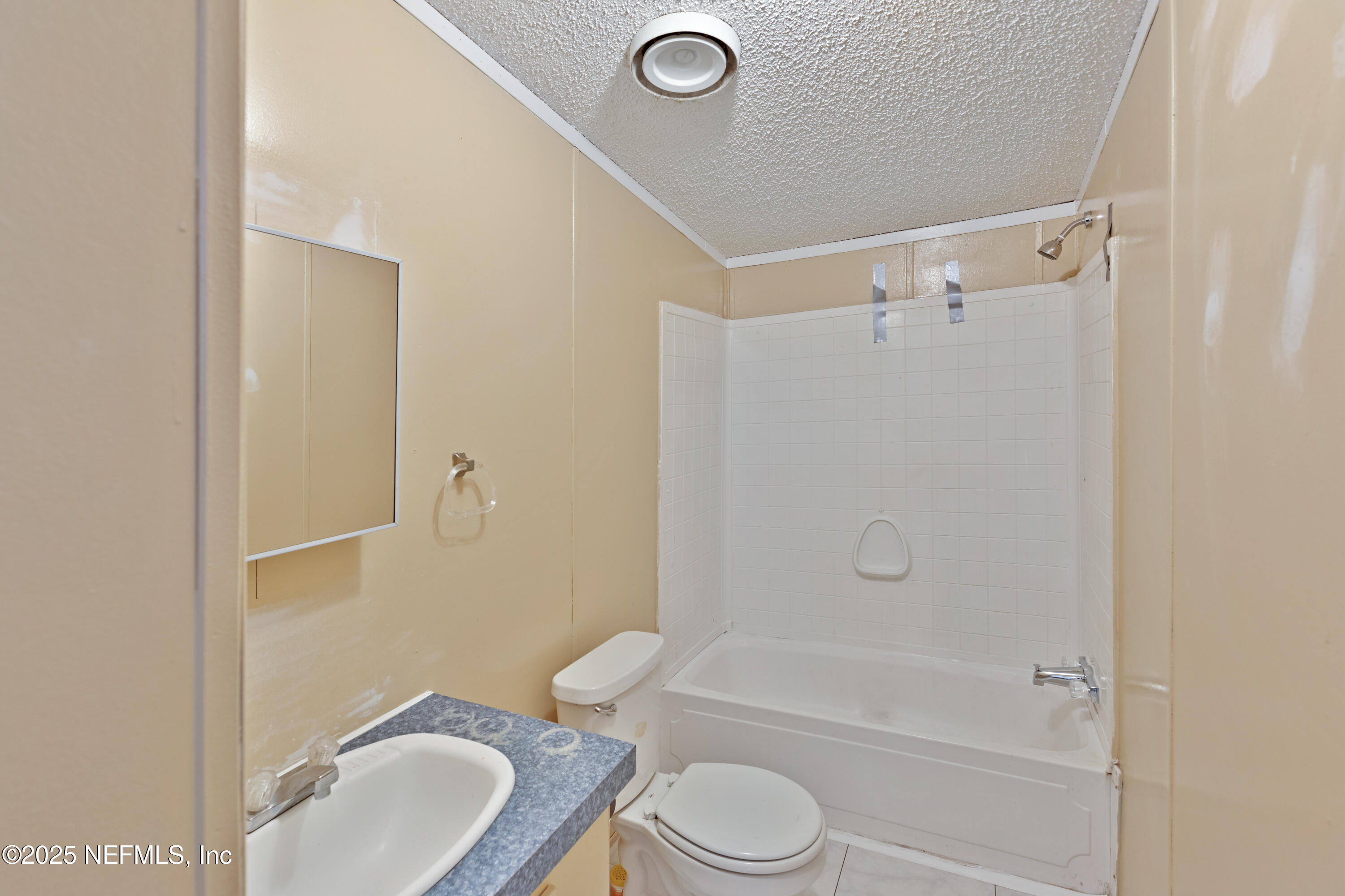 7463 Lilly Court Keystone Heights, FL 32656 - Photo 15 of 24 a bathroom with a granite countertop toilet a sink and bathtub