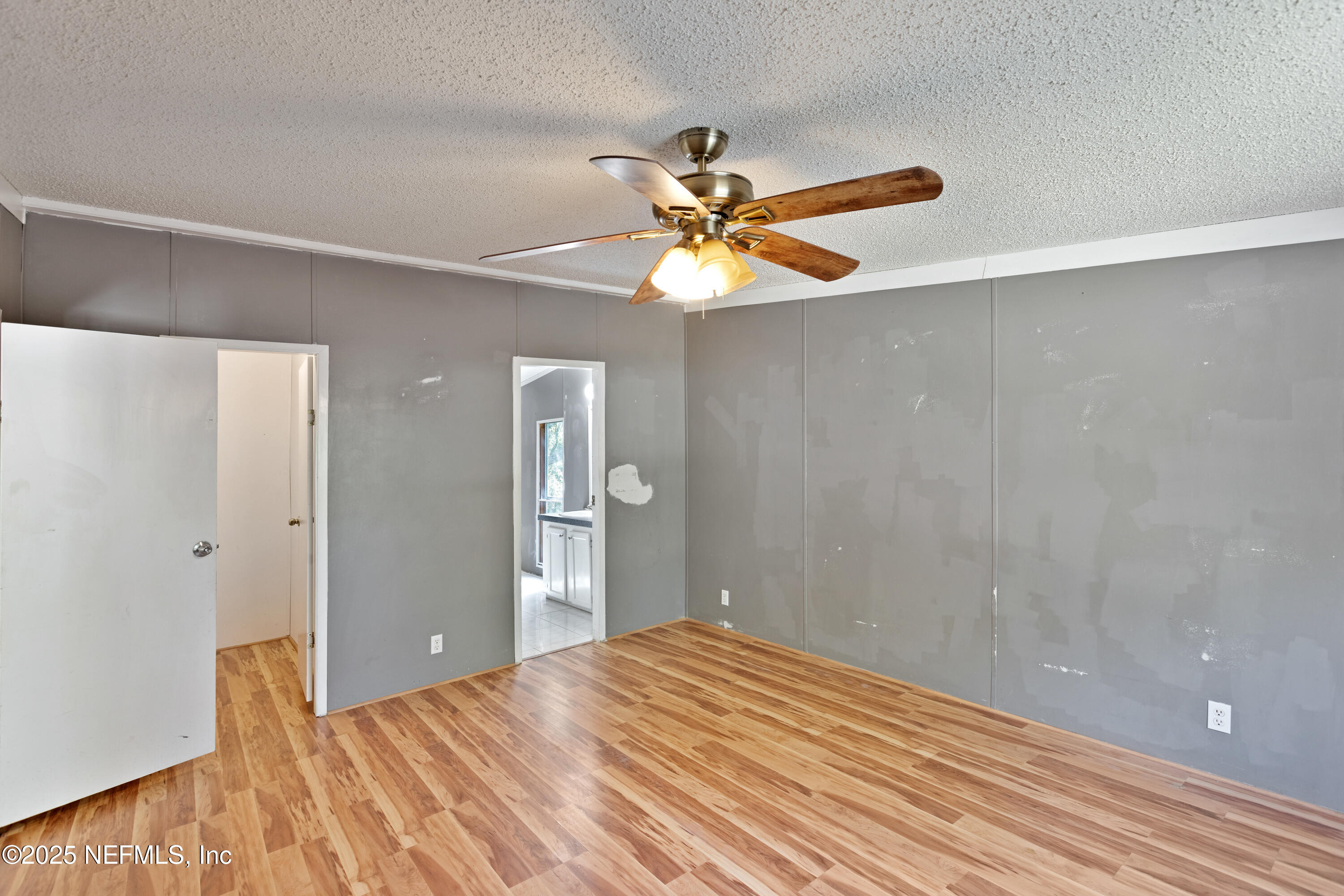 7463 Lilly Court Keystone Heights, FL 32656 - Photo 17 of 24 a view of a big room with wooden floor and a chandelier fan