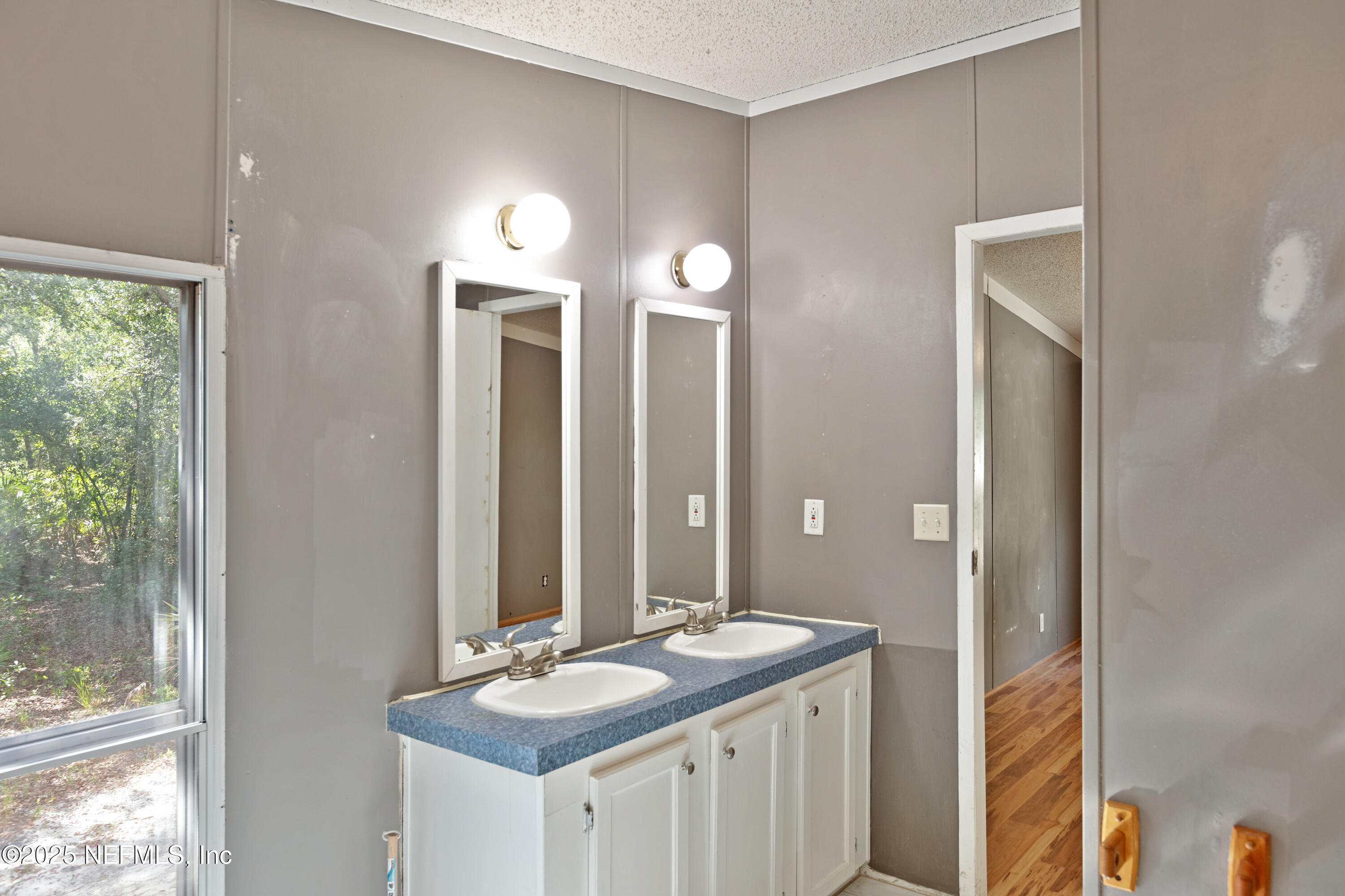 7463 Lilly Court Keystone Heights, FL 32656 - Photo 20 of 24 a bathroom with a granite countertop sink and a mirror