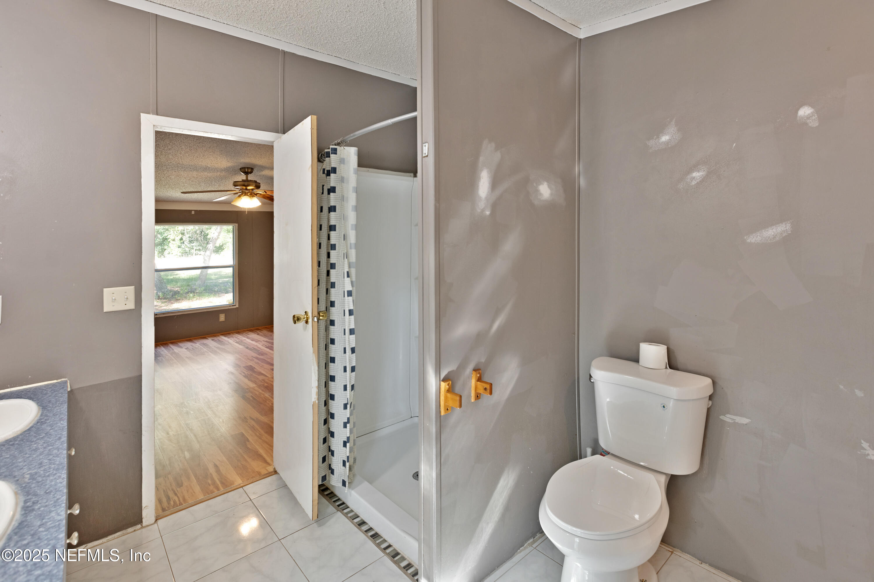 7463 Lilly Court Keystone Heights, FL 32656 - Photo 21 of 24 a bathroom with a toilet and a shower