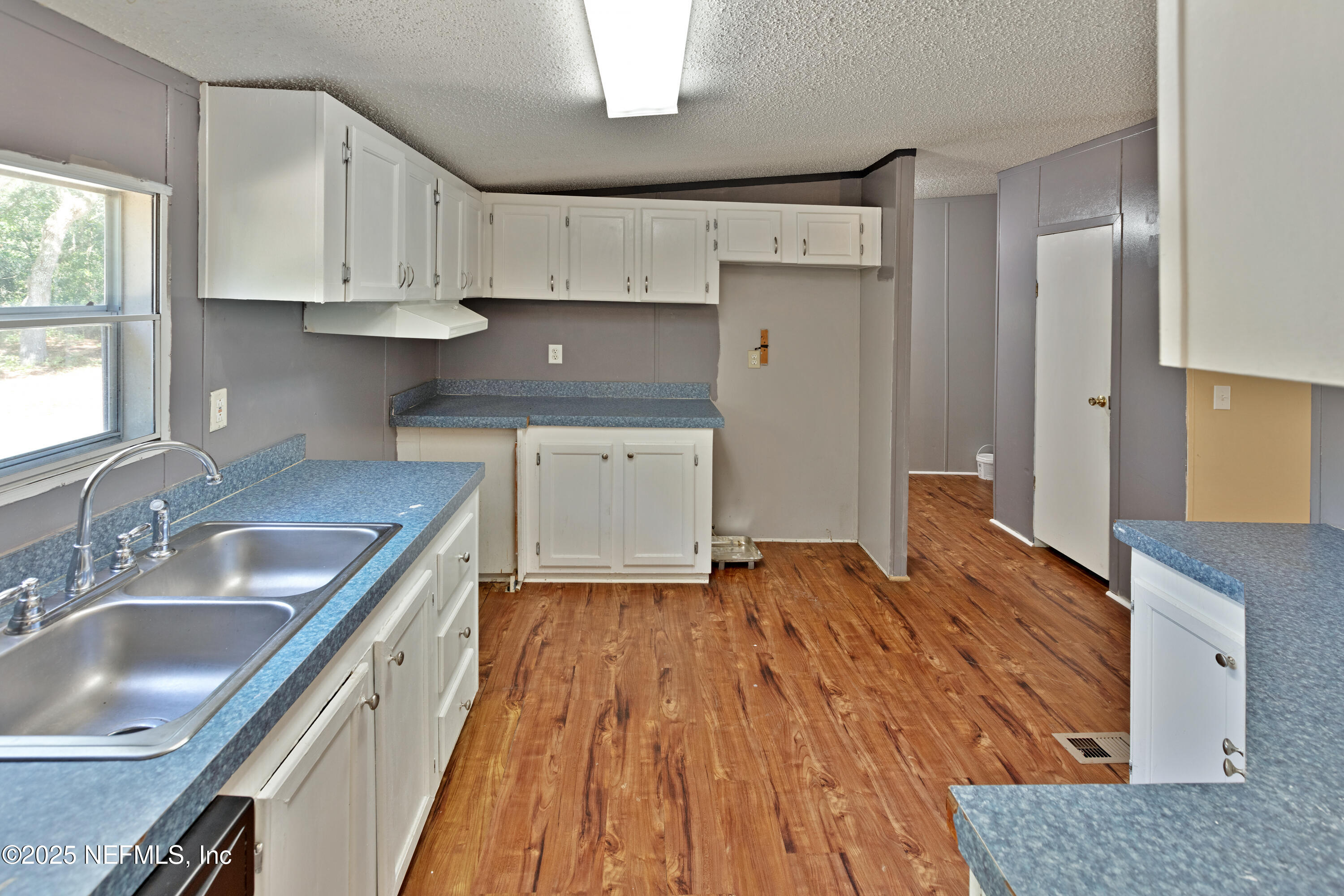 7463 Lilly Court Keystone Heights, FL 32656 - Photo 6 of 24 a kitchen with granite countertop a sink stove and cabinets