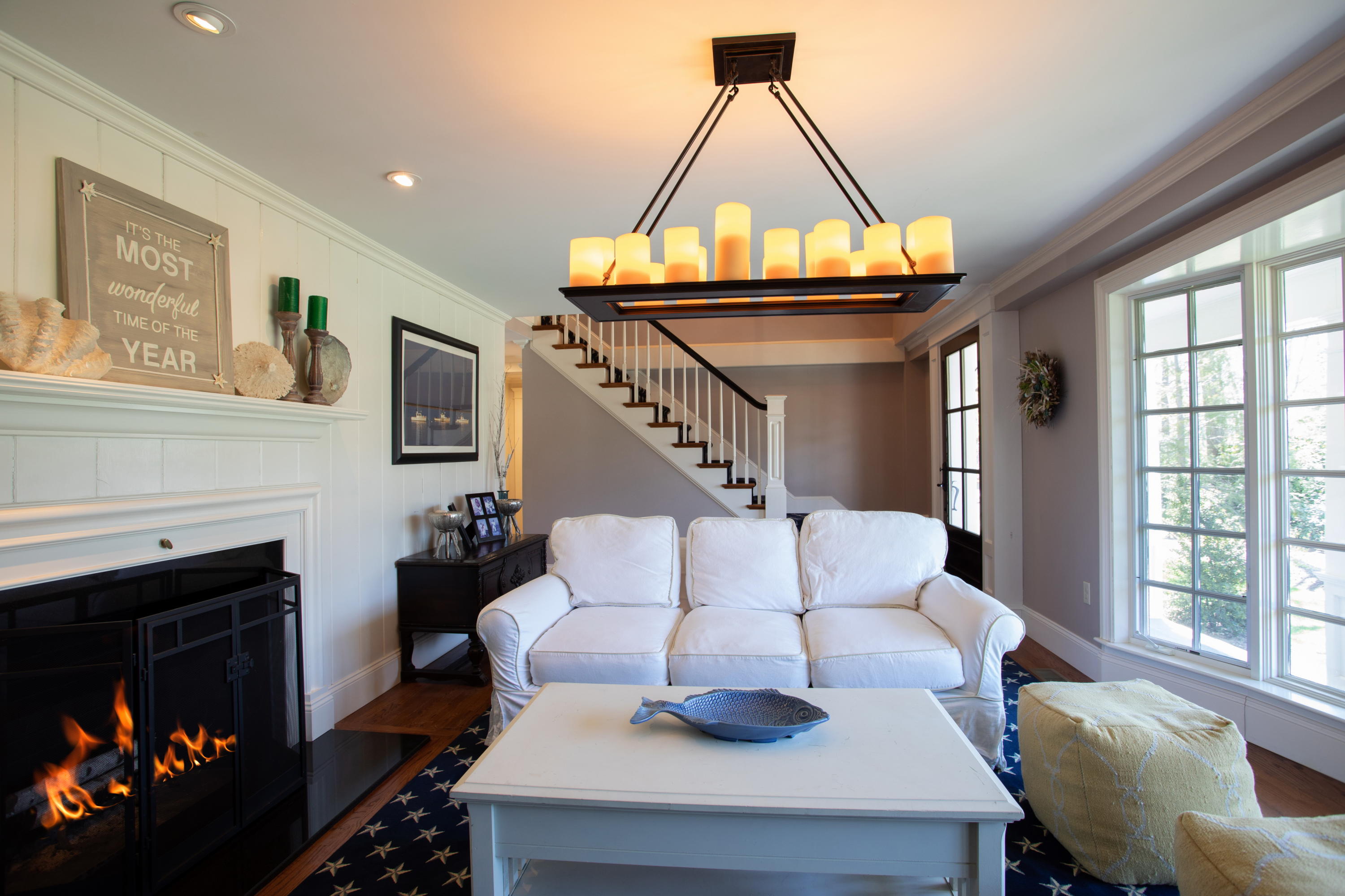 120 Smoke Valley Road Osterville, MA 02655 - Photo 12 of 64 a living room with furniture a fireplace and a large window