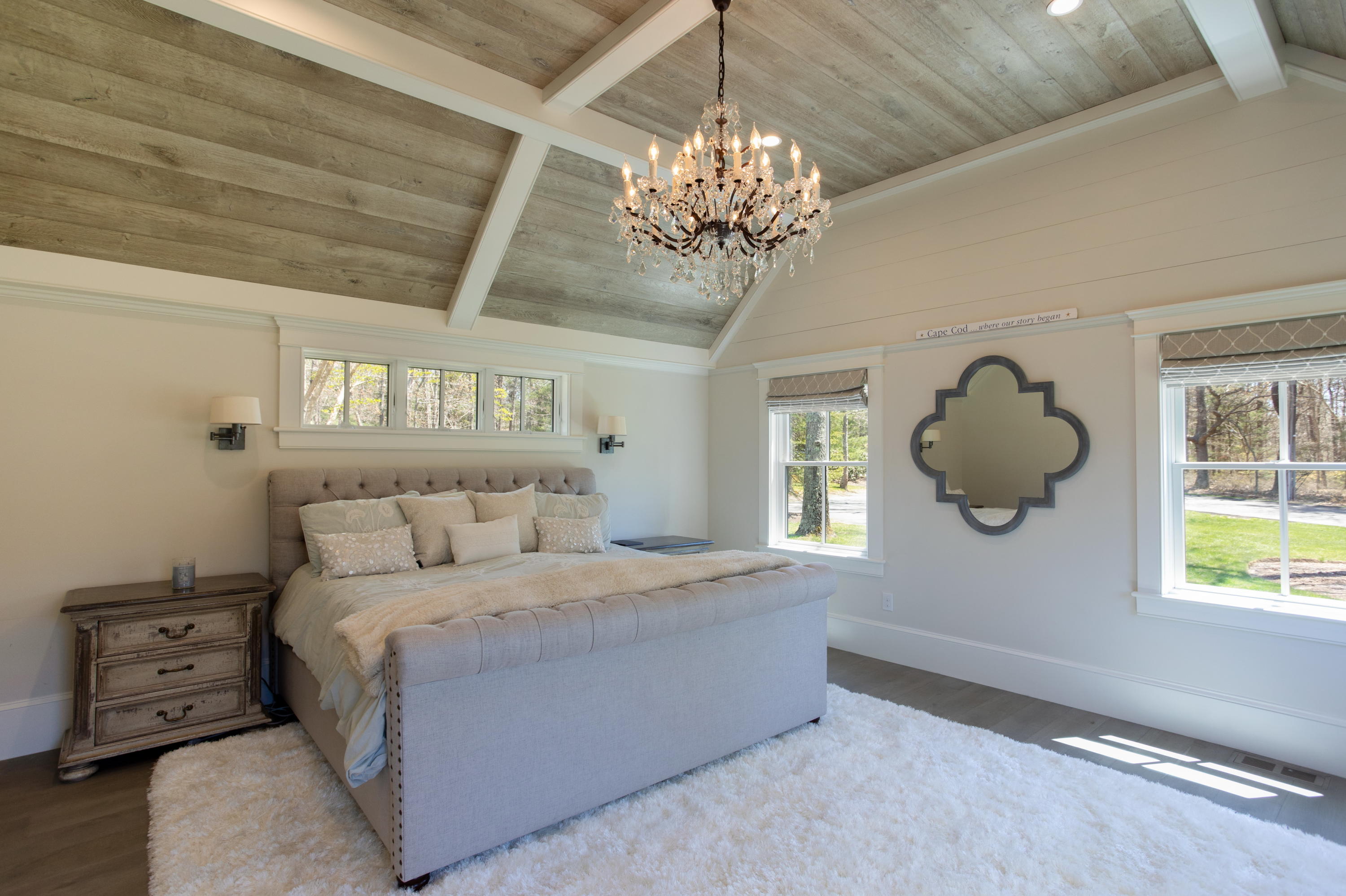 120 Smoke Valley Road Osterville, MA 02655 - Photo 19 of 64 a bedroom with a bed and a chandelier