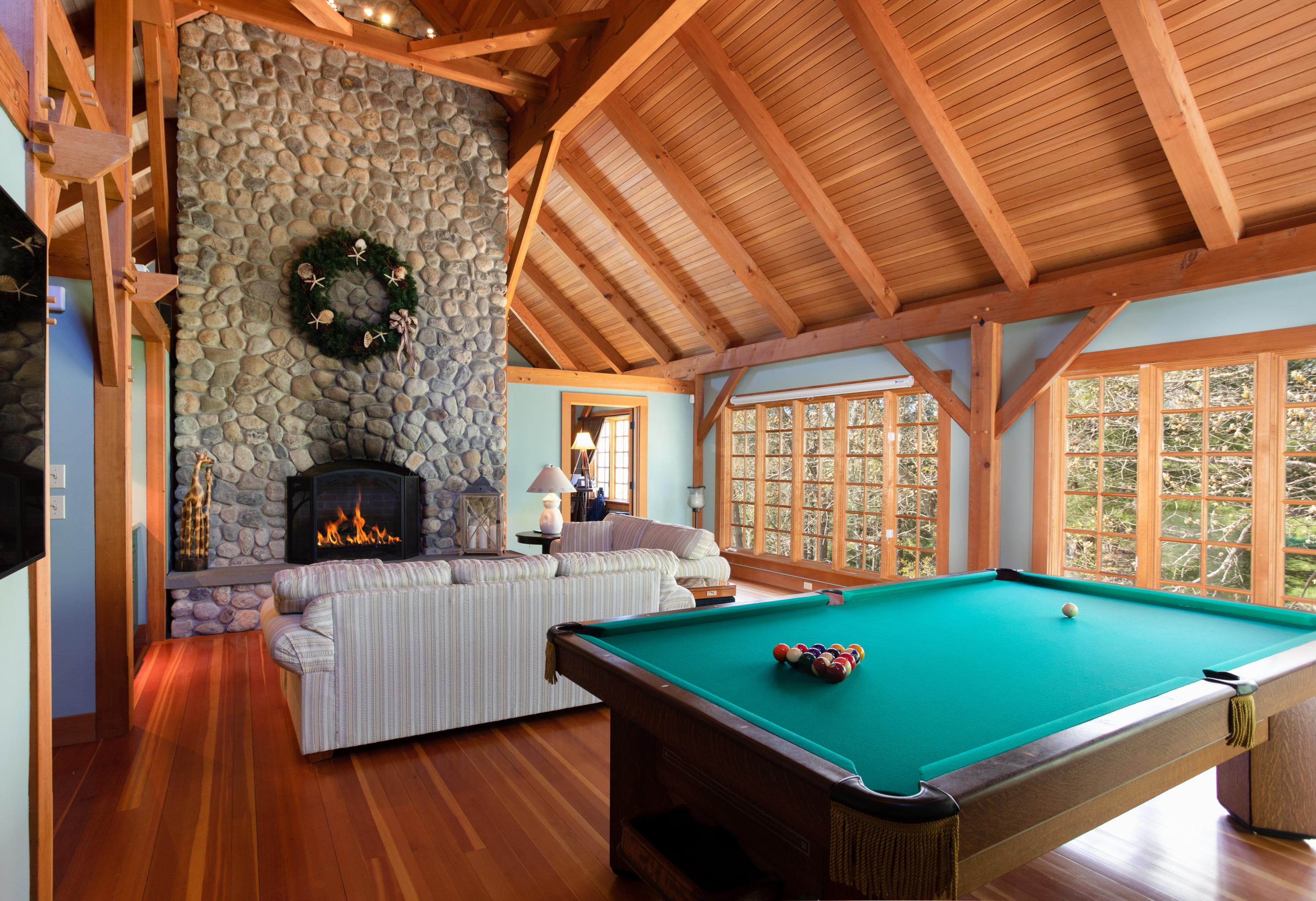 120 Smoke Valley Road Osterville, MA 02655 - Photo 32 of 64 a living room with a pool table and a fireplace