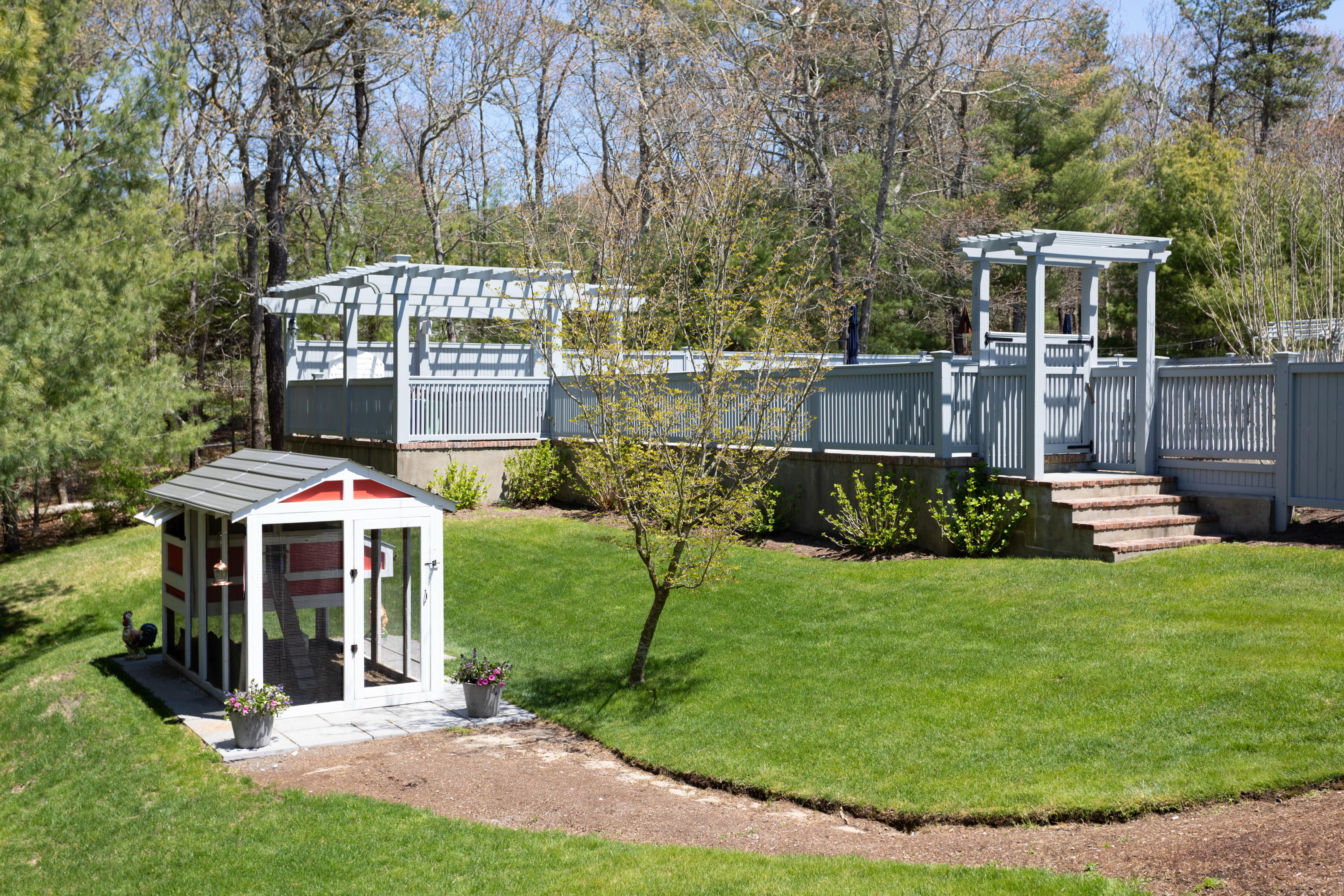 120 Smoke Valley Road Osterville, MA 02655 - Photo 51 of 64 a front view of a house with a yard table and chairs