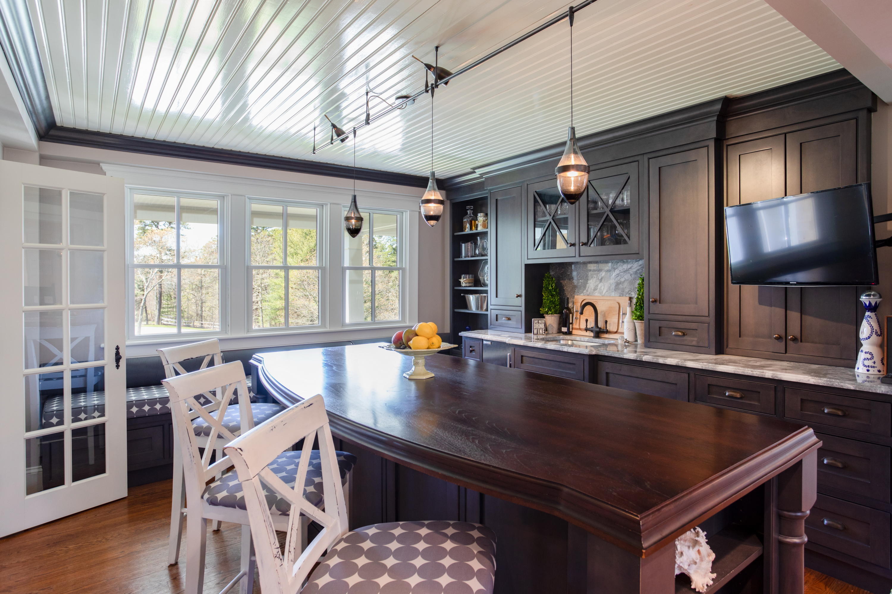 120 Smoke Valley Road Osterville, MA 02655 - Photo 8 of 64 a kitchen with stainless steel appliances granite countertop a stove a refrigerator a sink a dining table and chairs with wooden floor