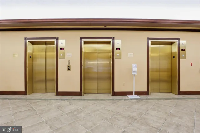 a view of a hallway with wooden chairs