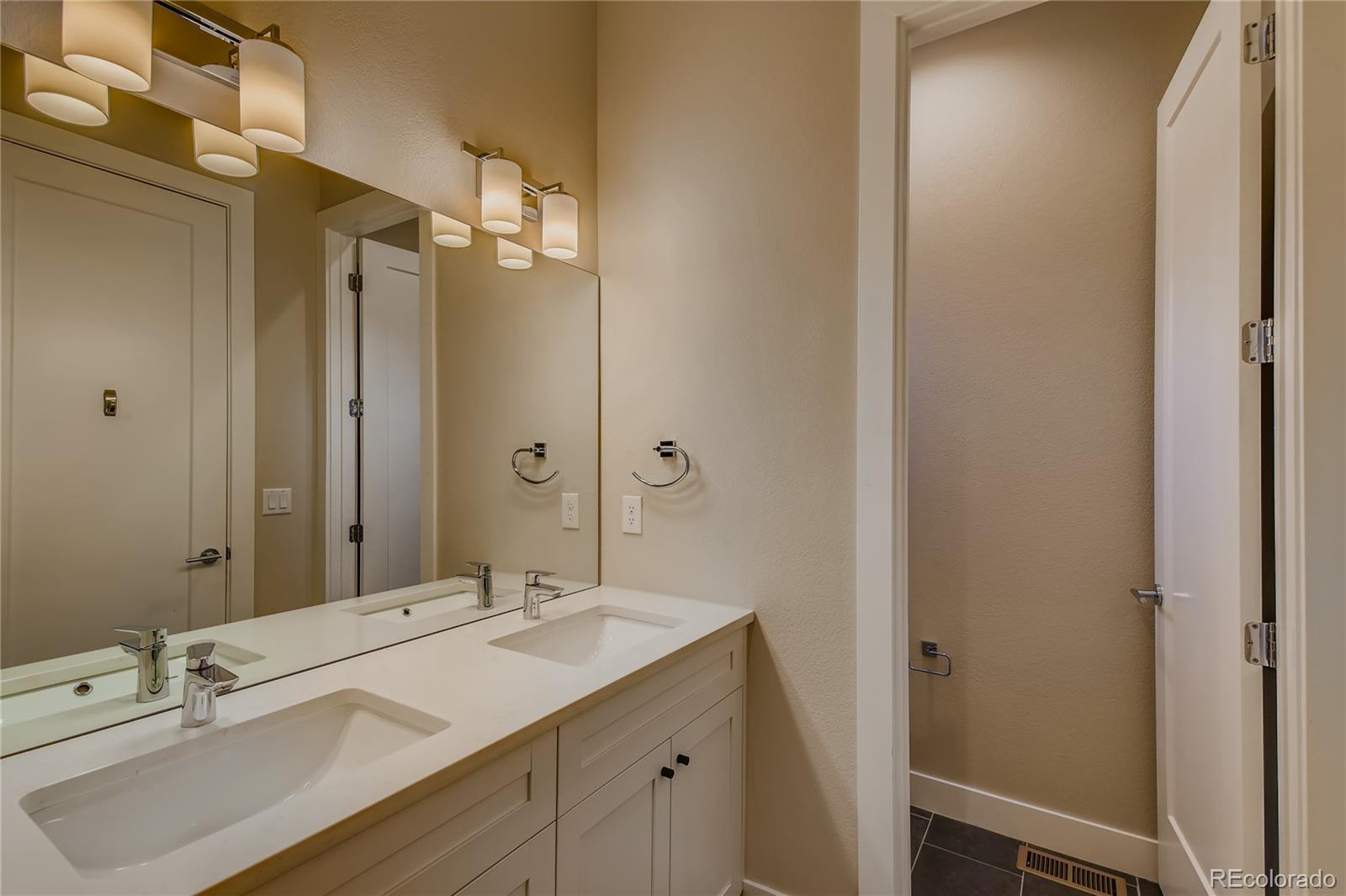 927 Inca Street, Unit 7 Denver, CO 80204 - Photo 33 of 38 a bathroom with a sink double vanity and a mirror