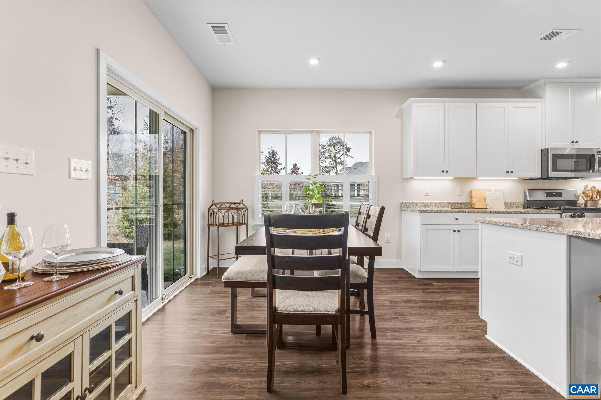 360 Winding Road Keswick, VA 22947 - Photo 24 of 48 a kitchen with kitchen island granite countertop wooden floors and white appliances