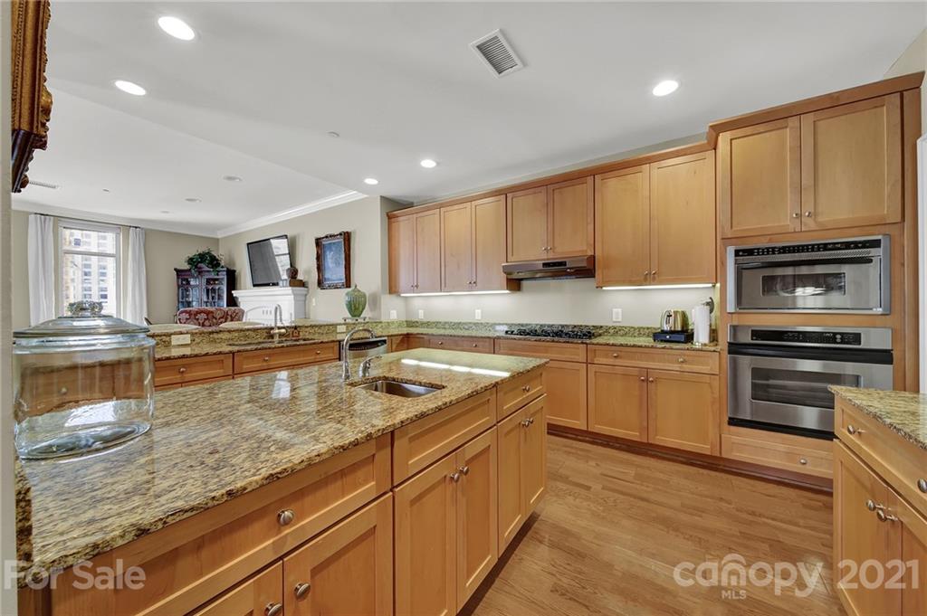 435 South Tryon Street, Unit 706 Charlotte, NC 28202 - Photo 12 of 40 a kitchen with stainless steel appliances granite countertop a stove sink and cabinets