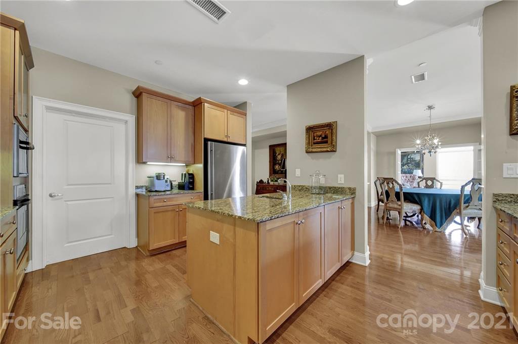 435 South Tryon Street, Unit 706 Charlotte, NC 28202 - Photo 14 of 40 a kitchen with stainless steel appliances granite countertop a refrigerator and a stove top oven