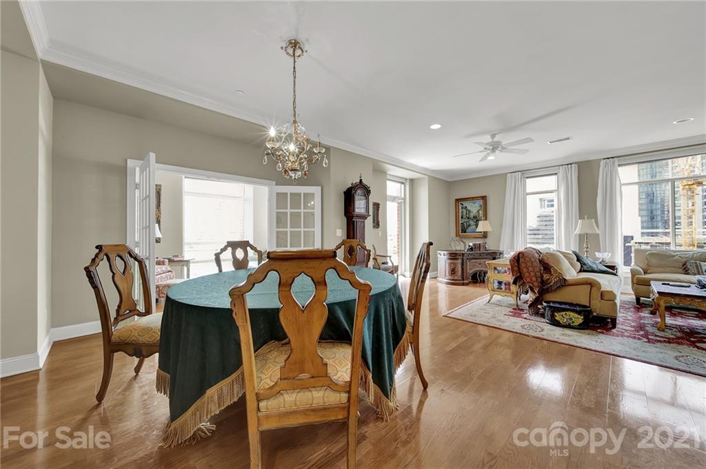 435 South Tryon Street, Unit 706 Charlotte, NC 28202 - Photo 16 of 40 a view of a dining room with furniture window and wooden floor