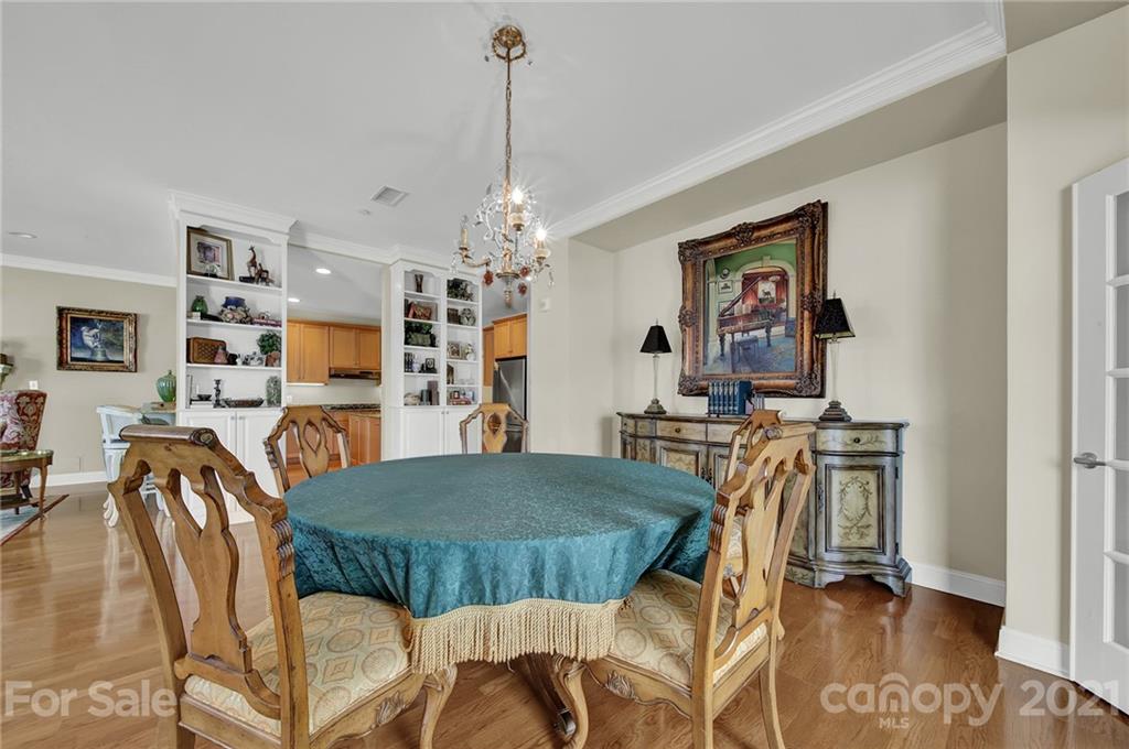 435 South Tryon Street, Unit 706 Charlotte, NC 28202 - Photo 18 of 40 a view of a dining room with furniture and wooden floor
