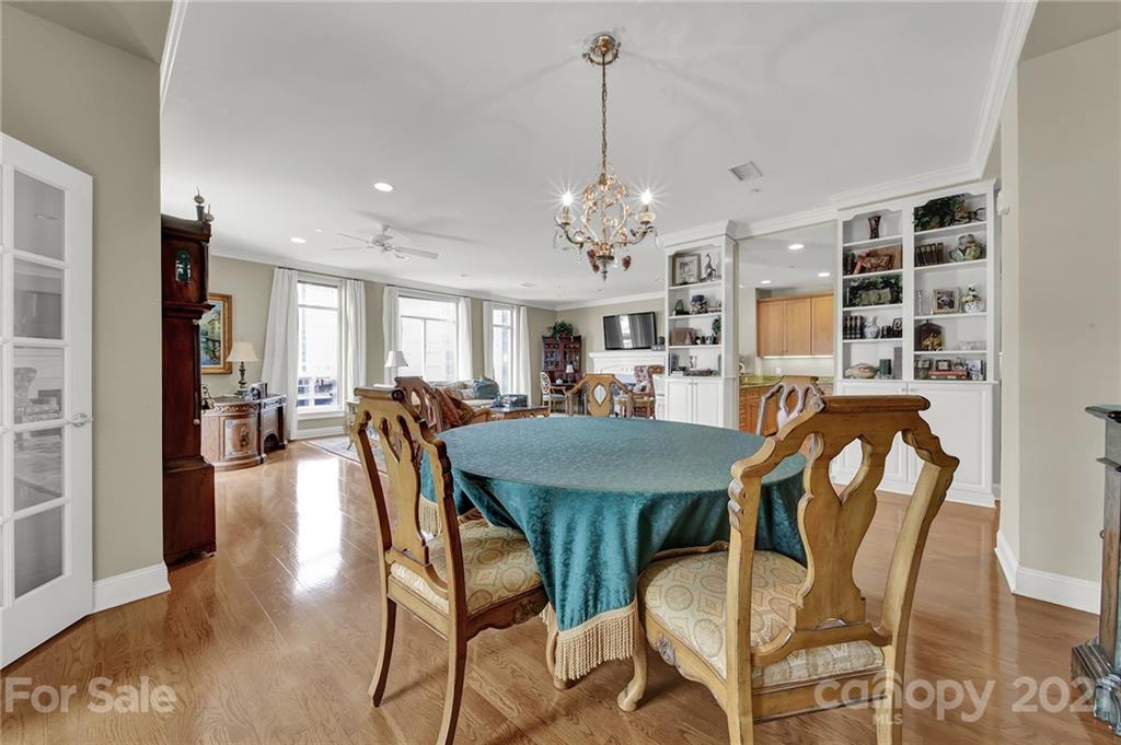 435 South Tryon Street, Unit 706 Charlotte, NC 28202 - Photo 19 of 40 a view of a dining room with furniture and chandelier