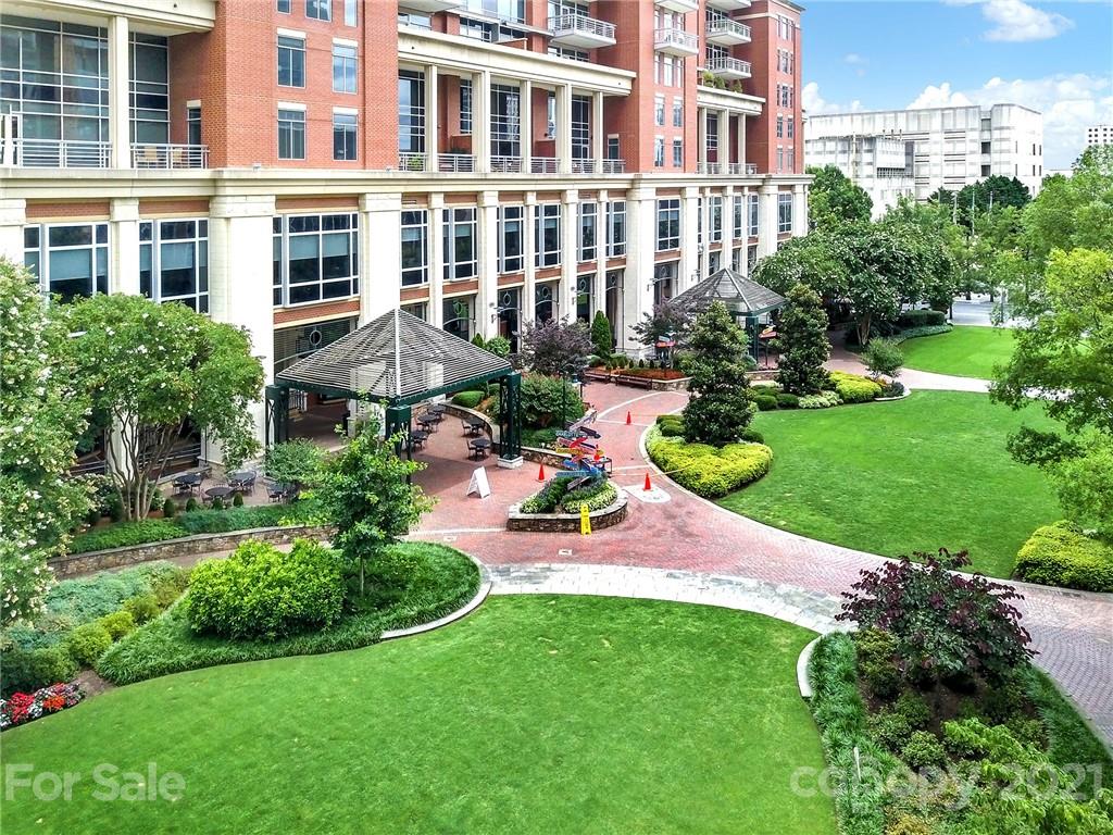 435 South Tryon Street, Unit 706 Charlotte, NC 28202 - Photo 3 of 40 a view of a patio with table and chairs and potted plants