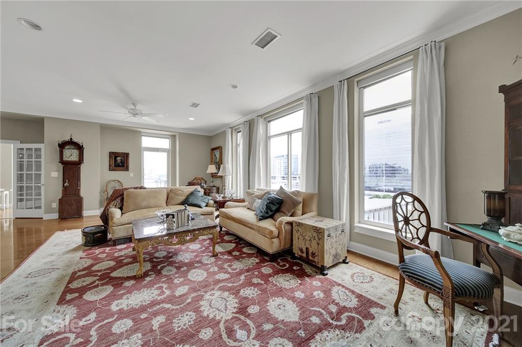 435 South Tryon Street, Unit 706 Charlotte, NC 28202 - Photo 24 of 40 a living room with furniture and large windows