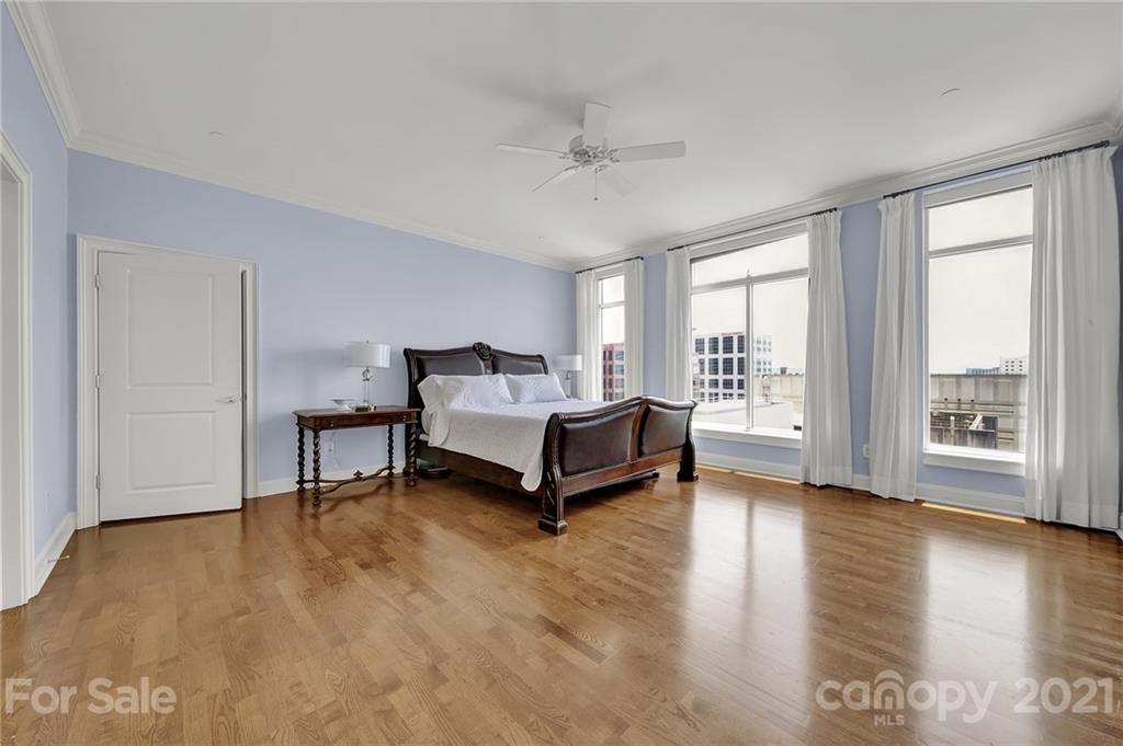 435 South Tryon Street, Unit 706 Charlotte, NC 28202 - Photo 27 of 40 a spacious bedroom with a bed and a large window