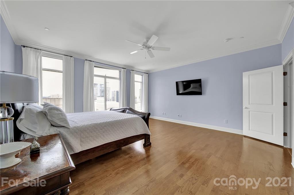 435 South Tryon Street, Unit 706 Charlotte, NC 28202 - Photo 29 of 40 a bedroom with furniture and wooden floor
