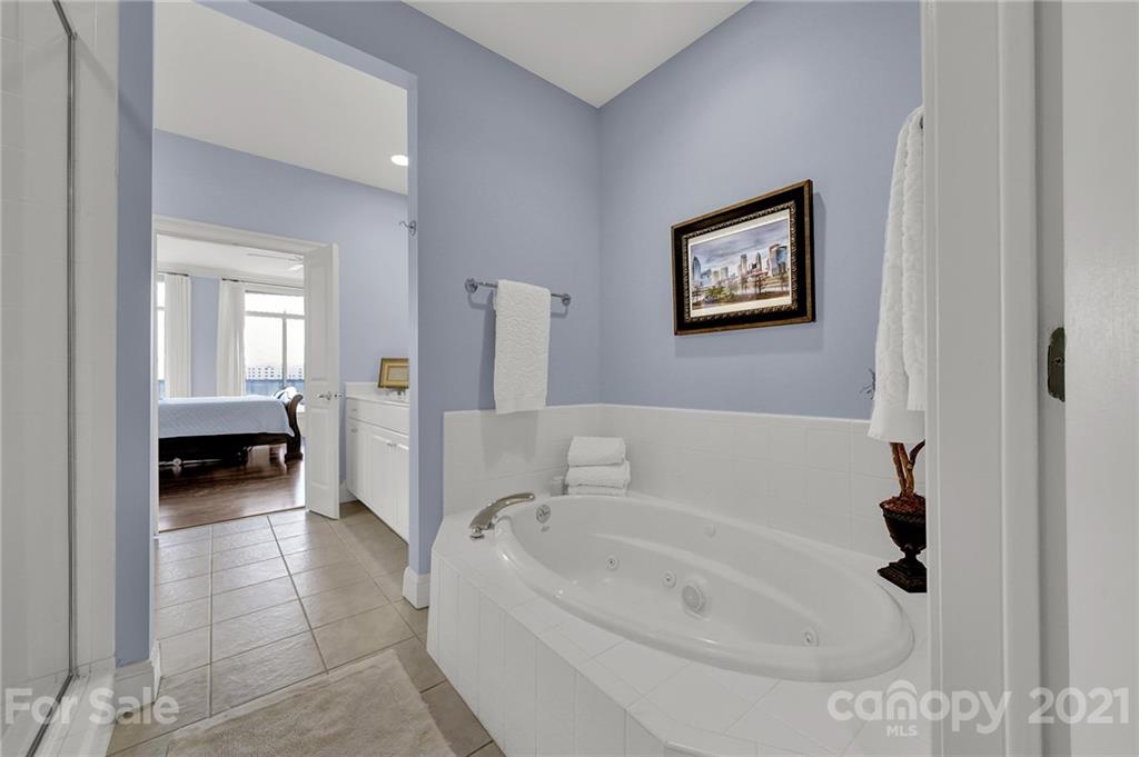 435 South Tryon Street, Unit 706 Charlotte, NC 28202 - Photo 31 of 40 a bathroom with a tub and a shower