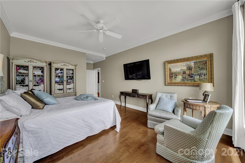 435 South Tryon Street, Unit 706 Charlotte, NC 28202 - Photo 33 of 40 a bedroom with a bed a couch and dresser
