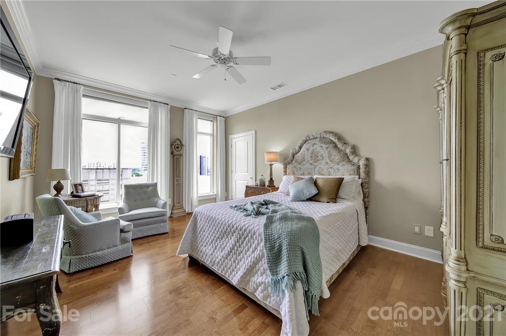 435 South Tryon Street, Unit 706 Charlotte, NC 28202 - Photo 35 of 40 a bedroom with a bed couch and window