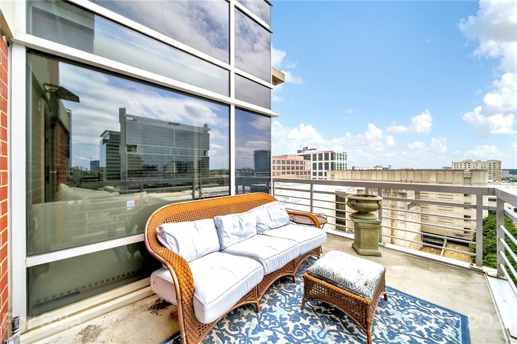 435 South Tryon Street, Unit 706 Charlotte, NC 28202 - Photo 37 of 40 a balcony with furniture and city view