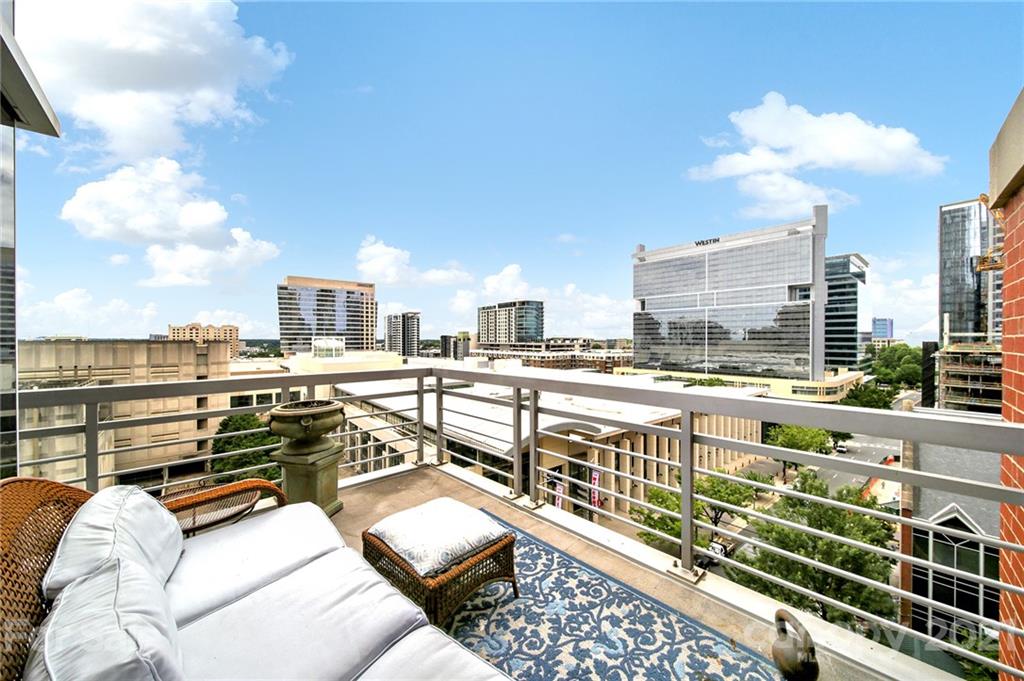 435 South Tryon Street, Unit 706 Charlotte, NC 28202 - Photo 5 of 40 a view of city from balcony with seating space