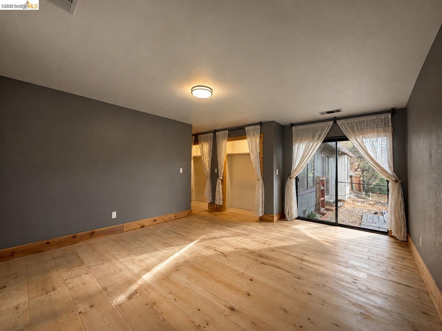 20663 Ferretti Road Groveland, CA 95321 - Photo 22 of 41 Wood-finish flooring, dark accent wall, recessed lighting, and sliding glass door