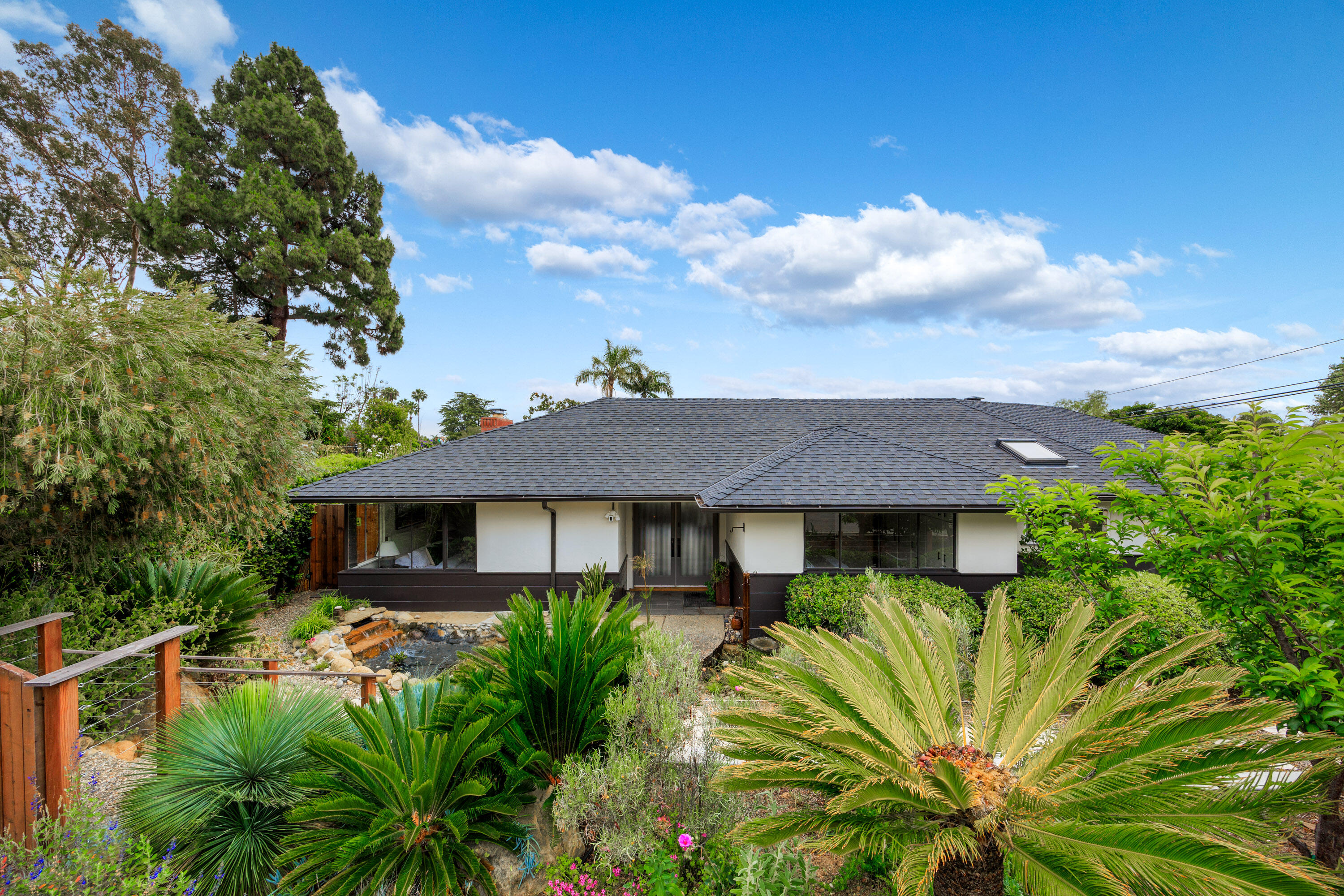 4 El Arco Drive Santa Barbara, CA 93105 - Photo 2 of 26 a view of a house next to a yard with plants and trees