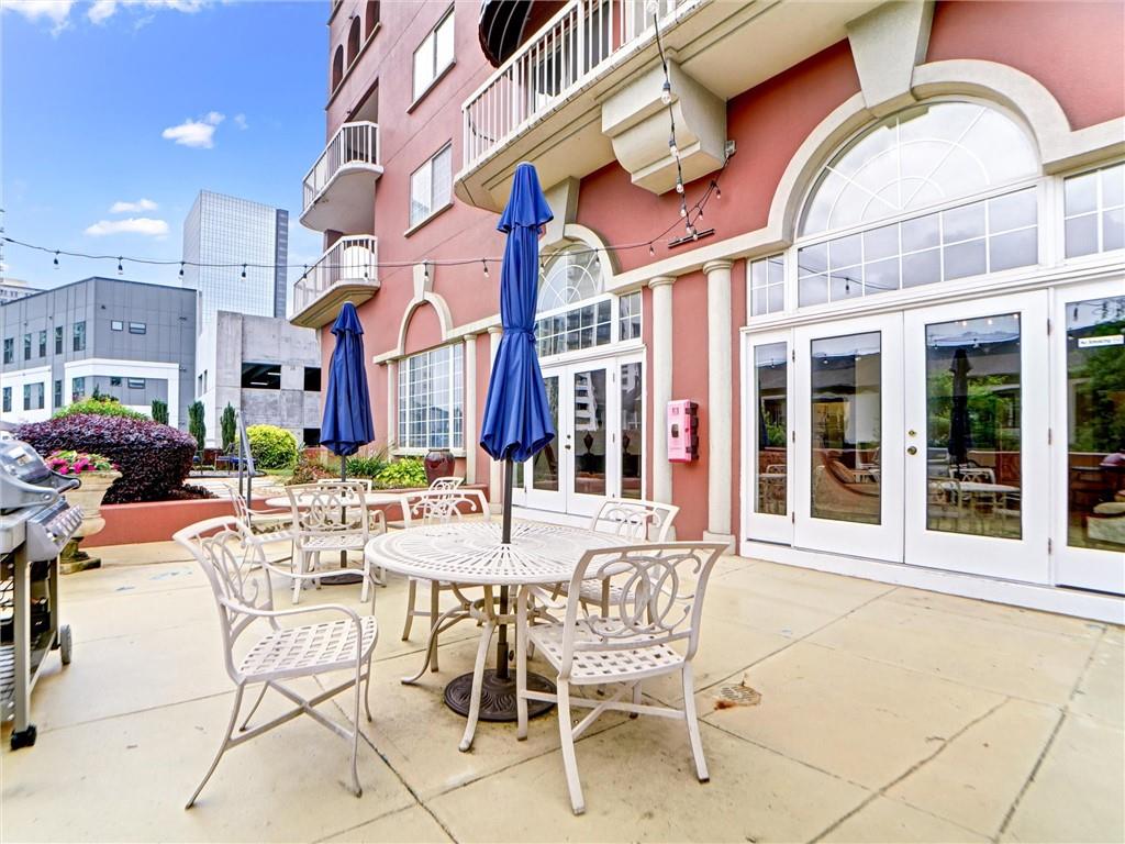 3435 Kingsboro Road Northeast, Unit 1601 Atlanta, GA 30326 - Photo 43 of 54 a view of a building with a table and chairs