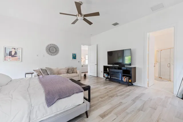 a bathroom with a granite countertop sink a mirror and a shower