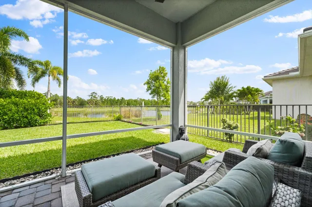a view of a porch with furniture and garden