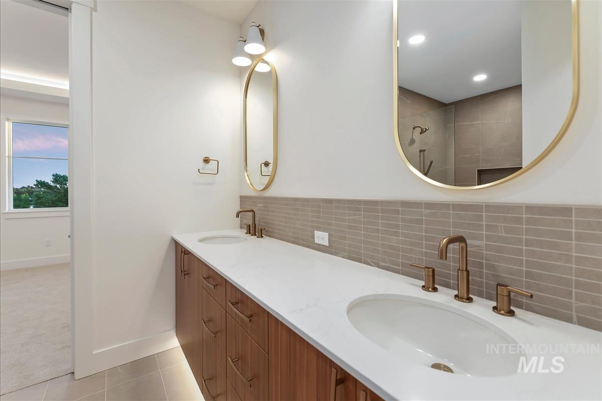 3213 West Moore Street Boise, ID 83702 - Photo 19 of 32 Bathroom featuring a dual vanity with wood-finish cabinetry, white countertops, and bronze-tone fixtures